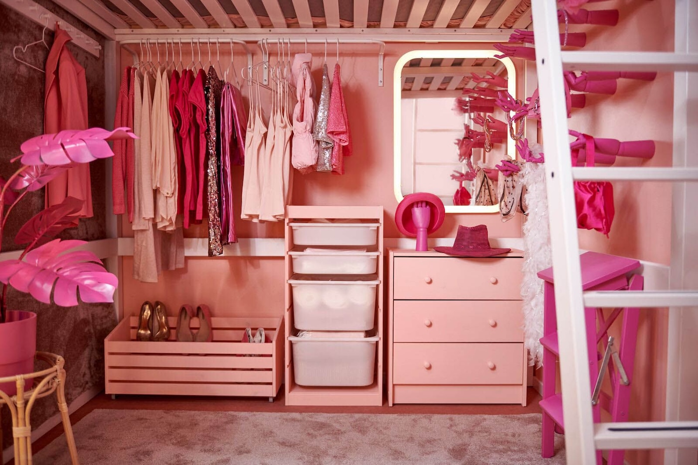 An all-pink bedroom with a pink dresser, loft bed, storage solutions and clothing, all in varying shades of pink.