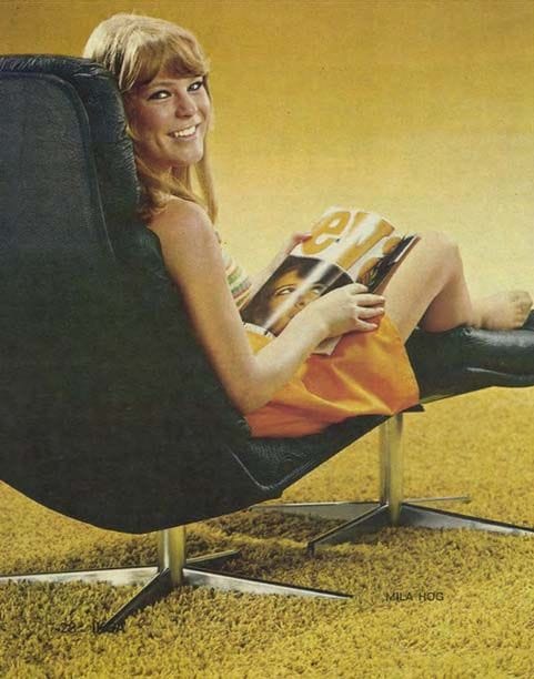 An image from the 1969 IKEA catalogue of a woman sitting on a swivel chair with her feet up on a footstool. She is smiling and holding a magazine.