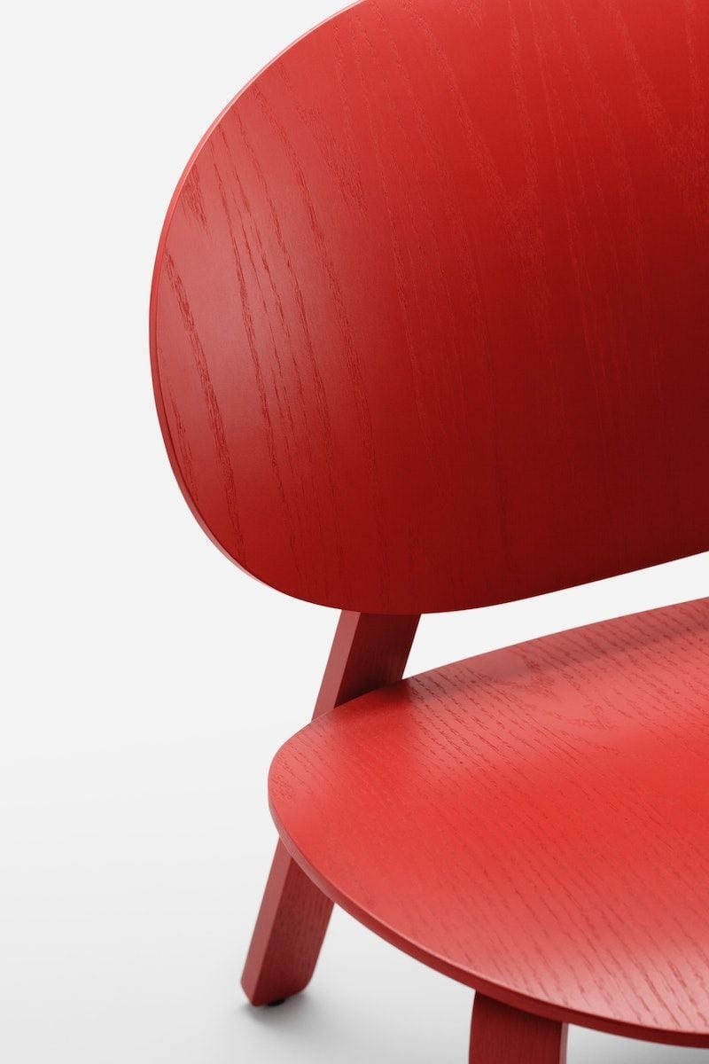 Elevated, close-up view of the FRÖSET chair in red-stained oak veneer with visible wood grains.