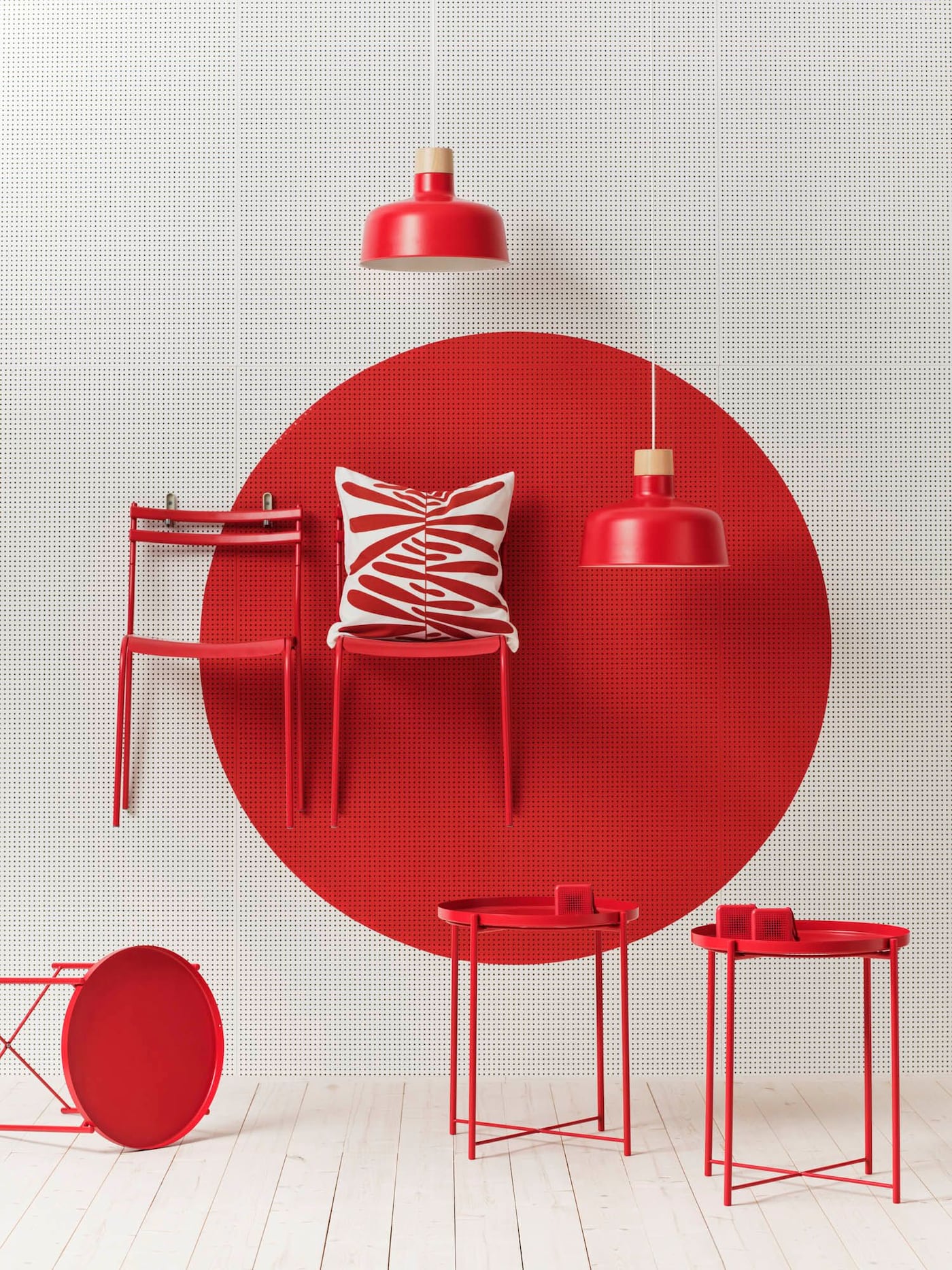 Red GENESÖN chairs mounted to a wall against a red-painted circle.