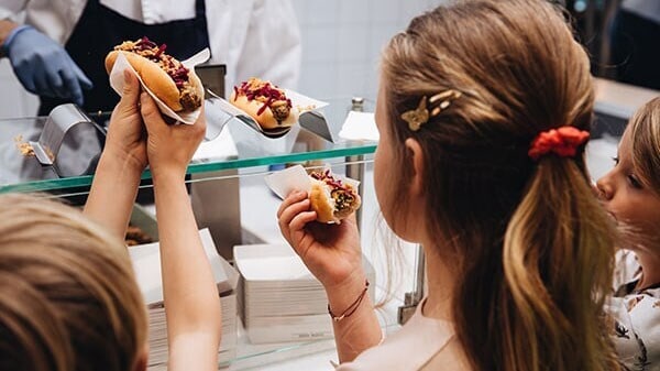 three-children-getting-veggie-hot-dogs-at-ikea-bistro-counter